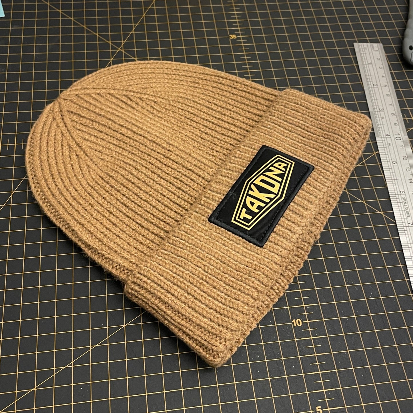 Biscuit Coloured Beanie with Gold Takona Logo